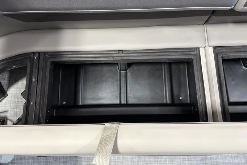 Slide: The Image of 2026 Premier 220 Sunscape RF XLC boat storage compartment with open lid, showcasing interior space. - 29