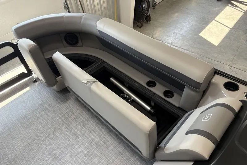 Slide: The Image of 2026 Premier 220 Sunscape RF XLC boat interior with gray seating and storage compartment. - 4