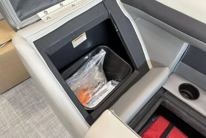 Slide: The Image of Open storage compartment in 2026 Premier 220 Sunscape RF XLC boat with cup holder. - 8