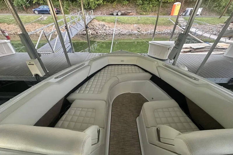 Slide: The Image of 2018 Cobalt R5 boat interior with luxurious seating on a serene lake. - 11