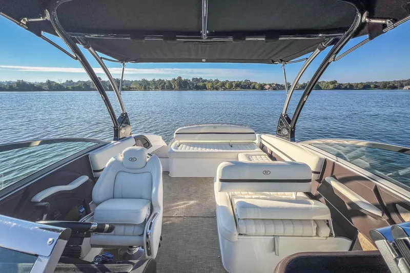 Slide: The Image of 2018 Cobalt R5 boat interior with luxurious seating on a serene lake. - 16