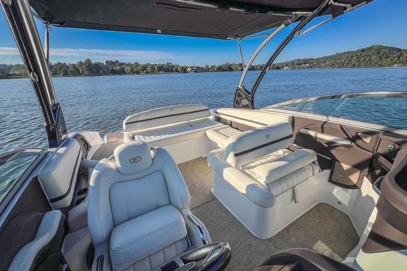 Slide: The Image of 2018 Cobalt R5 boat interior with luxurious seating on a serene lake. - 18
