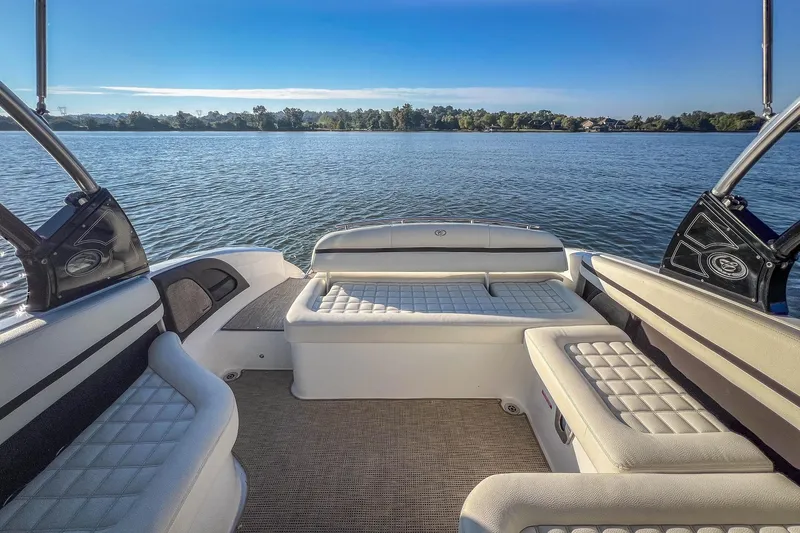 Slide: The Image of 2018 Cobalt R5 boat interior with cushioned seating, overlooking a serene lake view. - 19