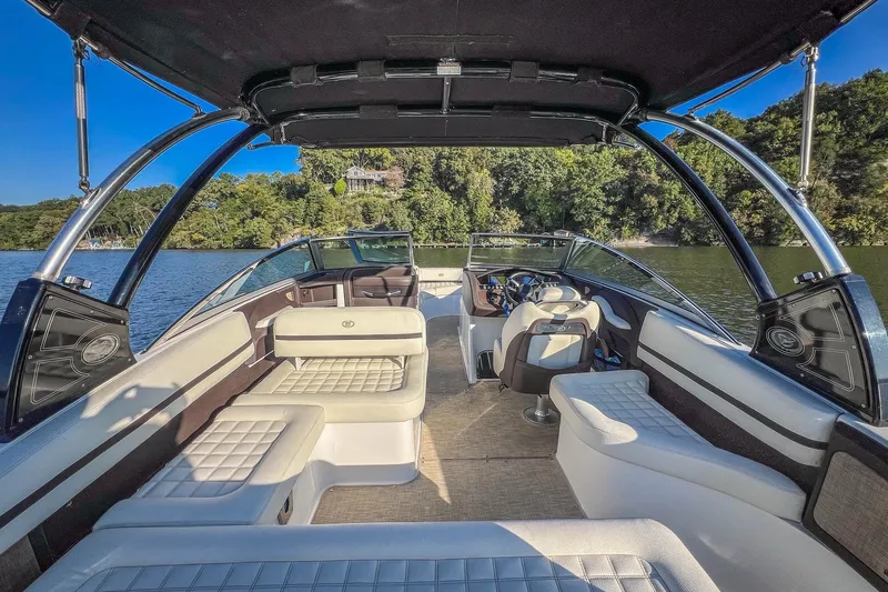 Slide: The Image of 2018 Cobalt R5 boat interior with luxurious seating on a scenic lake. - 21