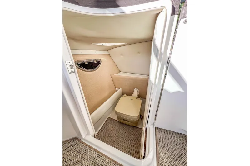 Slide: The Image of 2018 Cobalt R5 boat interior with compact restroom and portable toilet. - 22