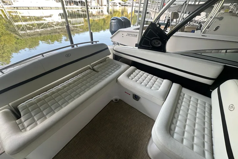 Slide: The Image of 2018 Cobalt R5 boat cruising on a scenic lake with lush green shoreline. - 4