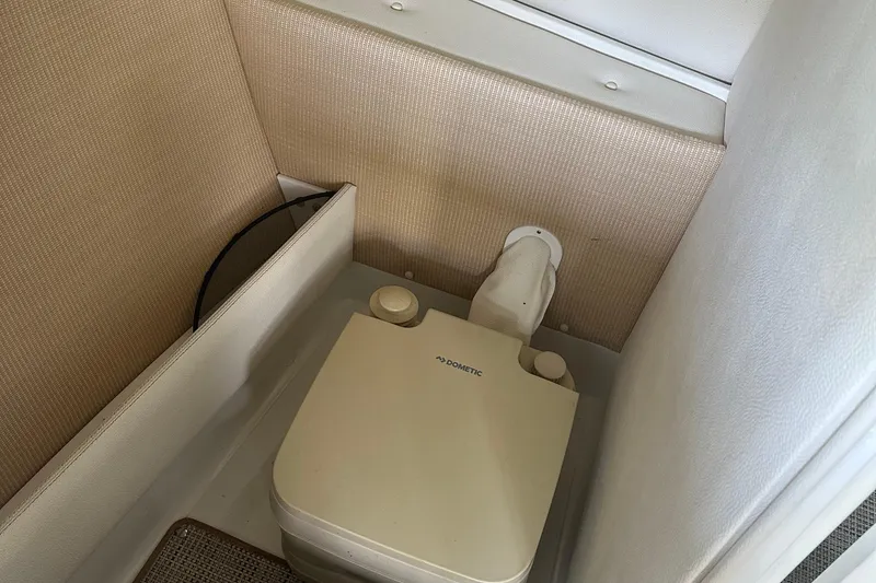 Slide: The Image of 2018 Cobalt R5 boat cruising on a scenic lake with lush green shoreline. - 5