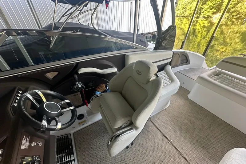 Slide: The Image of 2018 Cobalt R5 boat cruising on a serene lake with passengers onboard. - 8