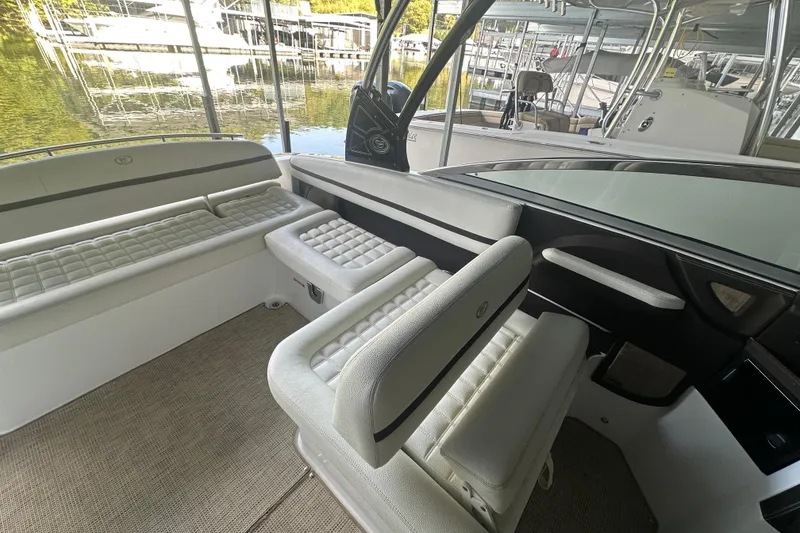 Slide: The Image of 2018 Cobalt R5 boat cruising on a scenic lake with lush green background. - 9