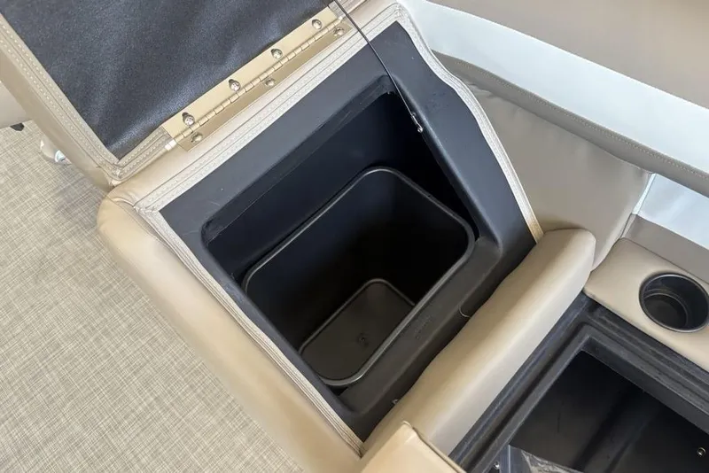 Slide: The Image of Open storage compartment in 2026 Premier 220 SUNSCAPE RL boat with beige upholstery. - 12