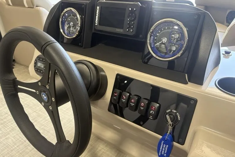 Slide: The Image of Steering console of 2026 Premier 220 SUNSCAPE RL with gauges and controls. - 14