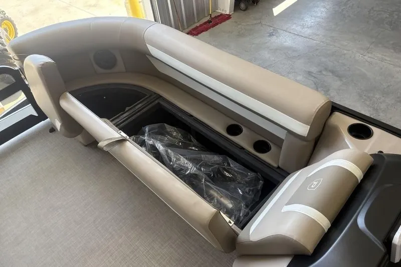 Slide: The Image of 2026 Premier 220 SUNSCAPE RL boat seating with cup holders and beige upholstery. - 21