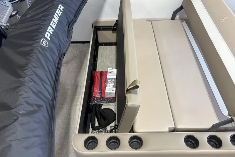 Slide: The Image of 2026 Premier 220 SUNSCAPE RL boat interior with beige seating and cup holders. - 26