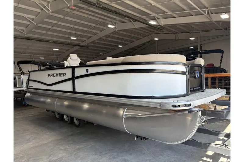 Slide: The Image of 2026 Premier 220 SUNSCAPE RL pontoon boat in a spacious indoor showroom. - 1