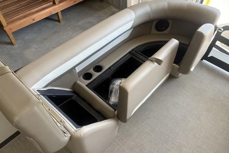 Slide: The Image of 2026 Premier 220 SUNSCAPE RL boat seating with storage compartments and cup holders. - 11