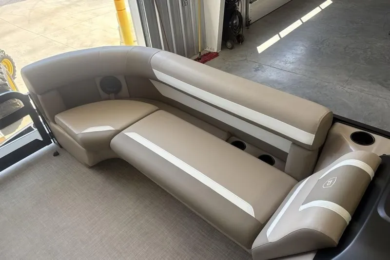 Slide: The Image of Storage compartment in 2026 Premier 220 SUNSCAPE RL boat, featuring cup holders and plastic-wrapped items. - 3