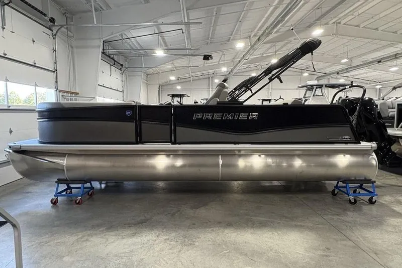 The Image of 2026 Premier 220 SUNSCAPE RL pontoon boat in a spacious indoor showroom. - 0