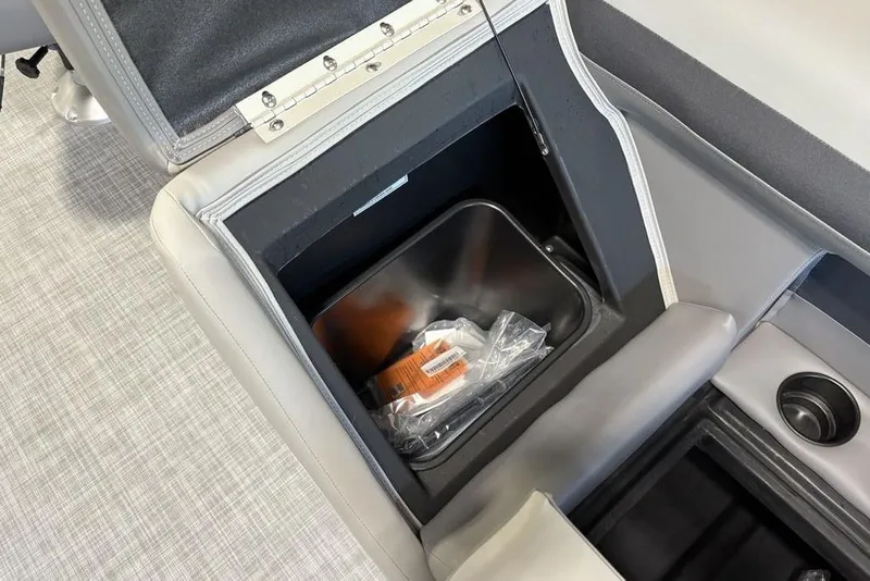 Slide: The Image of 2026 Premier 220 SUNSCAPE RL boat storage compartment with built-in cup holder. - 10