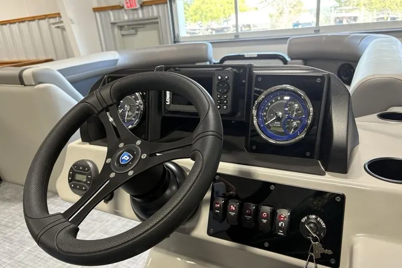 Slide: The Image of Steering console of 2026 Premier 220 SUNSCAPE RL boat with modern controls and gauges. - 16