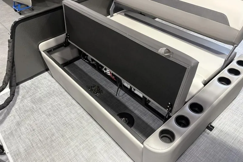 Slide: The Image of 2026 Premier 220 SUNSCAPE RL boat interior storage compartment with cup holders. - 18