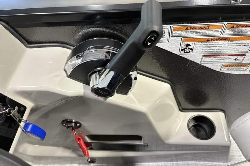 Slide: The Image of Control panel of 2026 Premier 220 SUNSCAPE RL boat with throttle and warning labels. - 20