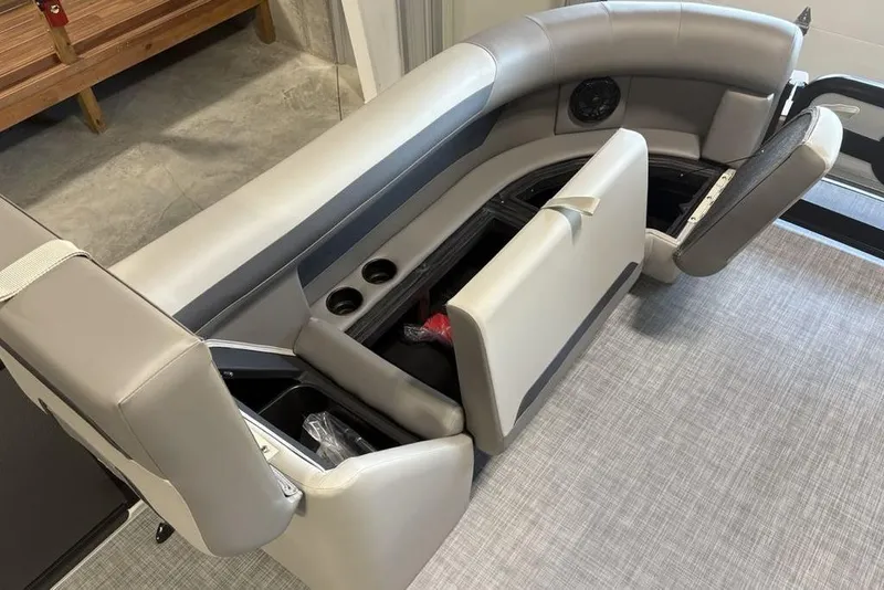 Slide: The Image of 2026 Premier 220 SUNSCAPE RL boat interior with storage compartments and cup holders. - 5