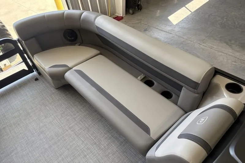 Slide: The Image of 2026 Premier 220 SUNSCAPE RL boat interior with gray cushioned seating and cup holders. - 4