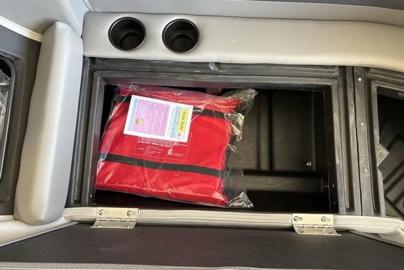 Slide: The Image of Storage compartment with red life jacket in 2026 Premier 220 SUNSCAPE RL boat. - 6
