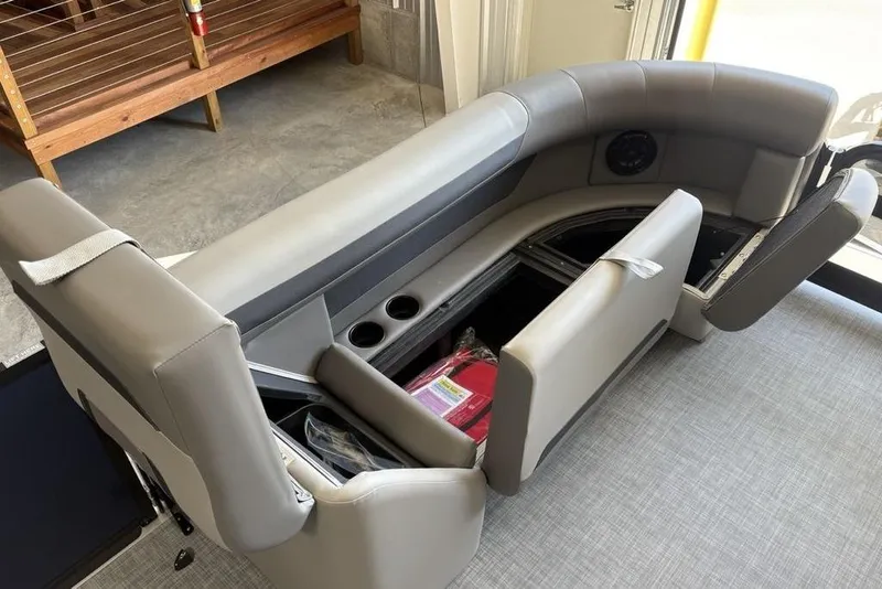 Slide: The Image of 2026 Premier 220 SUNSCAPE RL boat seating with storage compartments and cup holders. - 11