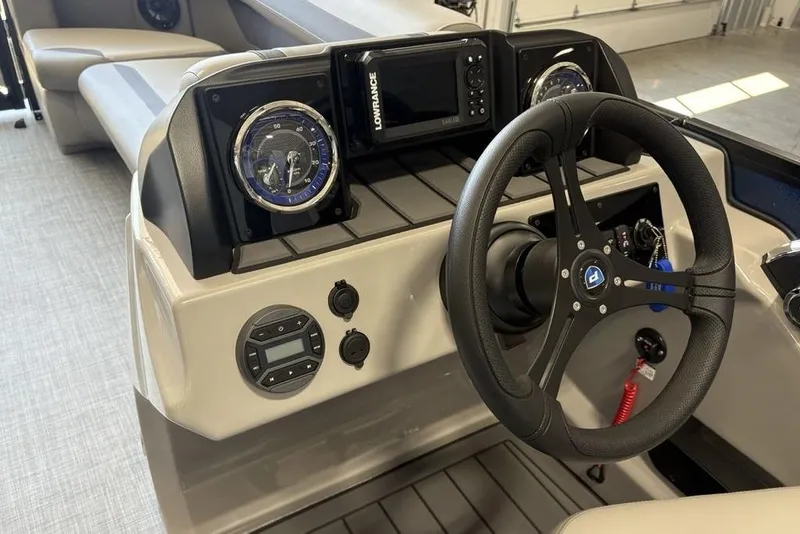 Slide: The Image of 2026 Premier 220 SUNSCAPE RL boat dashboard with steering wheel and control panel. - 15