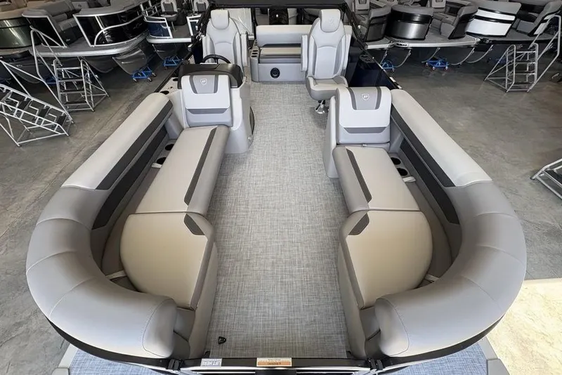 Slide: The Image of 2026 Premier 220 SUNSCAPE RL pontoon boat with spacious seating in showroom. - 20