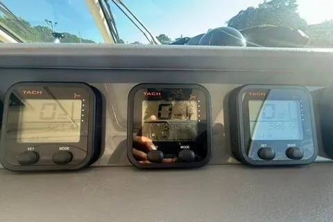 Slide: The Image of Digital tachometers on a 2010 Pursuit OS 375 Offshore boat dashboard. - 11