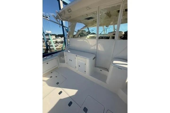 Slide: The Image of 2010 Pursuit OS 375 Offshore boat interior with seating and storage compartments. - 4