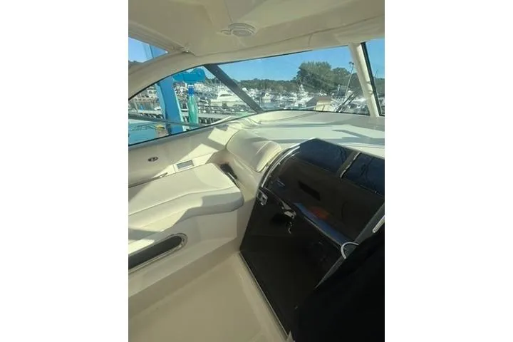 Slide: The Image of 2010 Pursuit OS 375 Offshore boat interior with helm and seating area. - 7