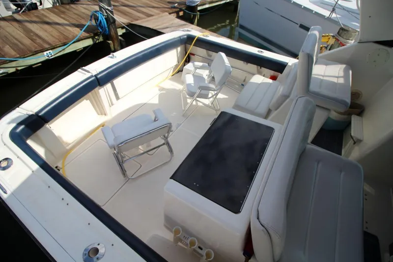 Slide: The Image of 1996 Tiara Yachts 3300 Open boat interior with seating and deck view. - 10