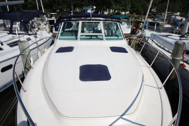 Slide: The Image of 1996 Tiara Yachts 3300 Open docked, showcasing sleek design and spacious deck. - 13