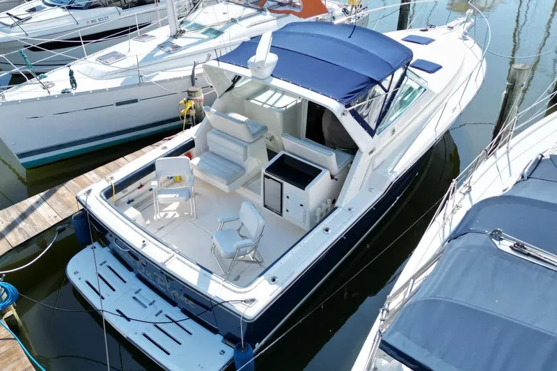 Slide: The Image of 1996 Tiara Yachts 3300 Open docked, featuring spacious deck and seating area. - 5