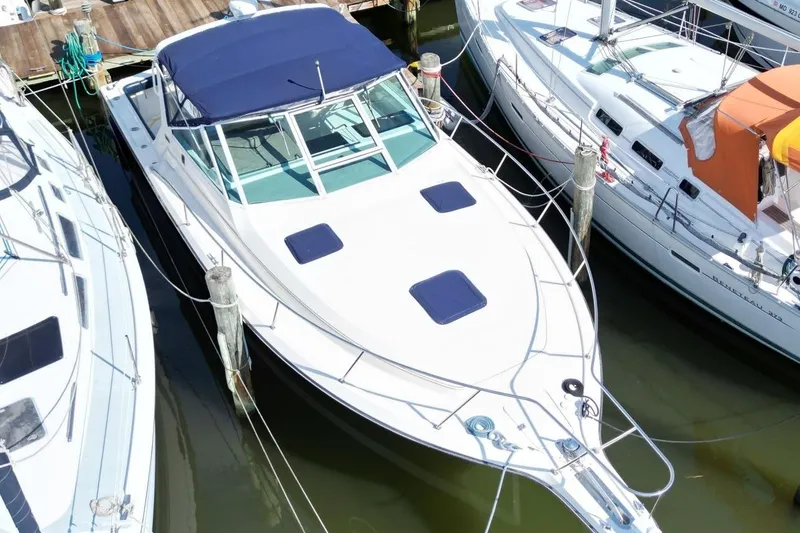 Slide: The Image of 1996 Tiara Yachts 3300 Open docked among other boats in a marina. - 6
