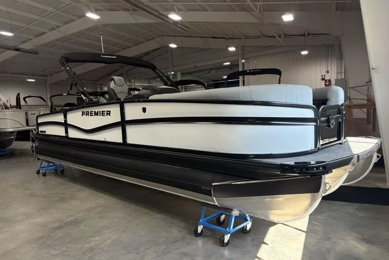 Slide: The Image of 2026 Premier 250 Solaris RS CL pontoon boat in showroom, side view. - 1