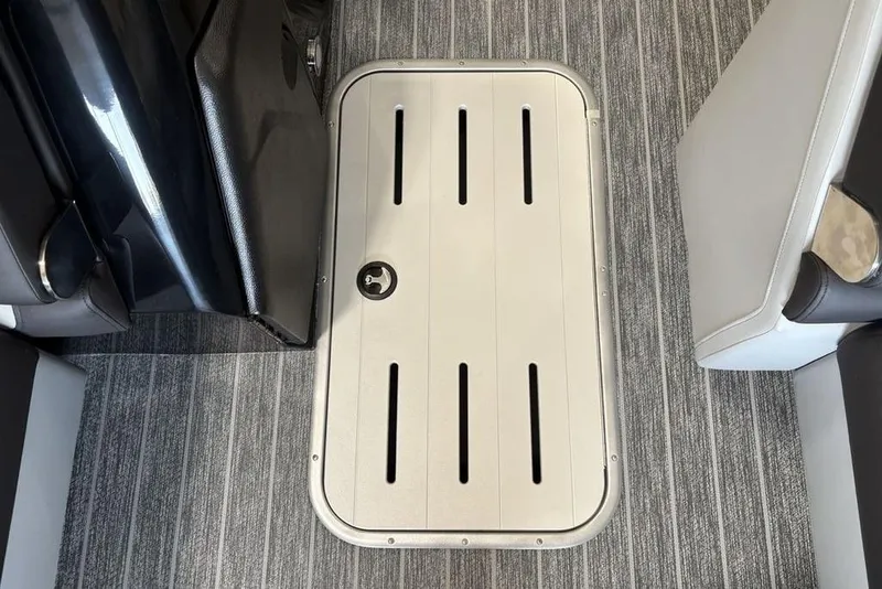 Slide: The Image of Floor hatch on 2026 Premier 250 Solaris RS CL boat, surrounded by striped carpet. - 10