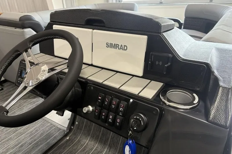 Slide: The Image of 2026 Premier 250 Solaris RS CL boat dashboard with steering wheel and Simrad display. - 17