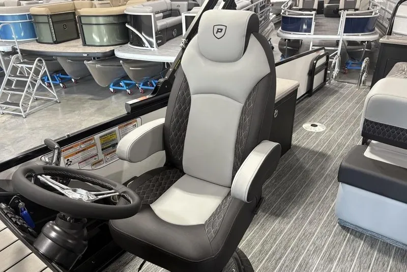 Slide: The Image of Captain's chair and steering wheel of 2026 Premier 250 Solaris RS CL pontoon boat. - 24