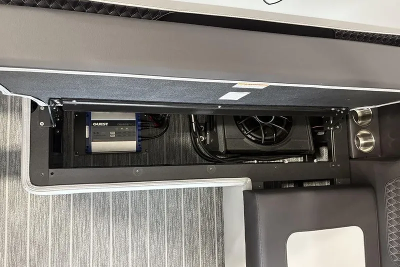 Slide: The Image of Interior view of 2026 Premier 250 Solaris RS CL boat, showcasing storage compartment and electrical components. - 34
