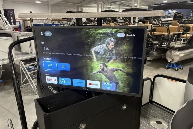 Slide: The Image of 2026 Premier 250 Solaris RS CL with Google TV display in a showroom. - 35