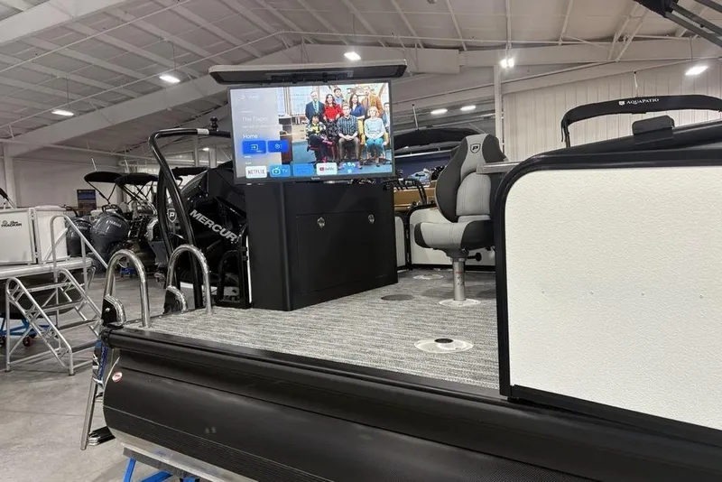 Slide: The Image of 2026 Premier 250 Solaris RS CL pontoon boat with TV screen in showroom. - 37