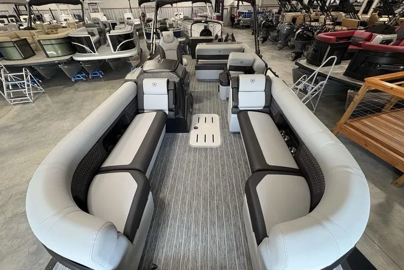 Slide: The Image of 2026 Premier 250 Solaris RS CL pontoon boat interior with luxurious seating in showroom. - 38