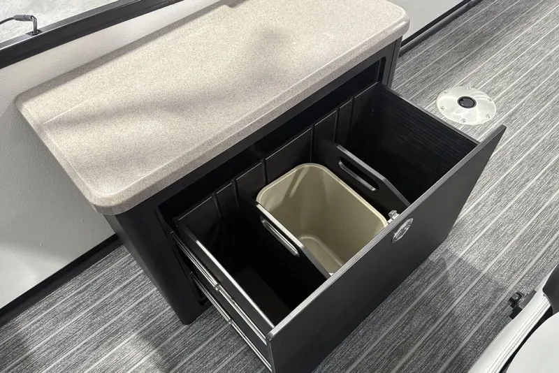 Slide: The Image of Premier 250 Solaris RS CL 2026 interior with open storage drawer and waste bin. - 41