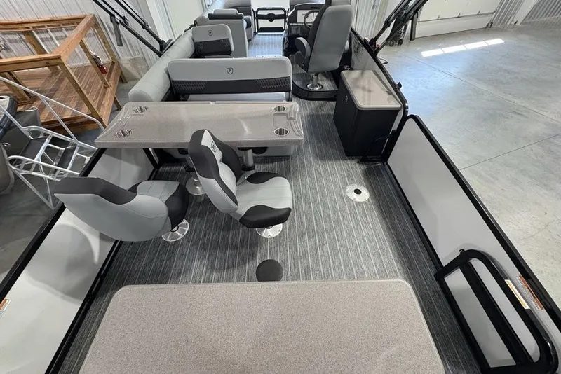 Slide: The Image of 2026 Premier 250 Solaris RS CL pontoon boat interior with modern seating and table setup. - 42