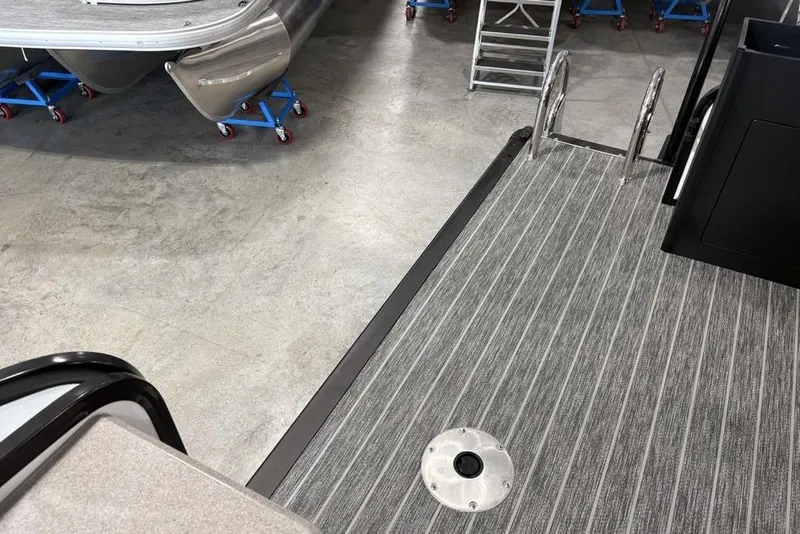 Slide: The Image of 2026 Premier 250 Solaris RS CL boat interior with striped flooring and metal ladder. - 43