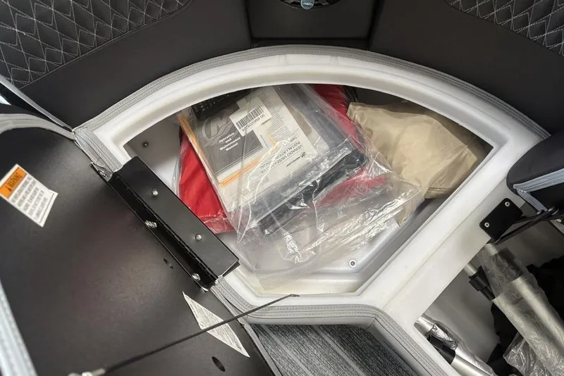Slide: The Image of Storage compartment of 2026 Premier 250 Solaris RS CL, containing various packaged items. - 8
